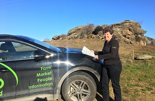 image of B+LNZ staff member infront of branded car