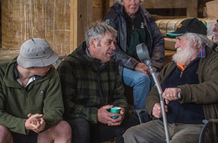 image of farmers chatting in woolshed