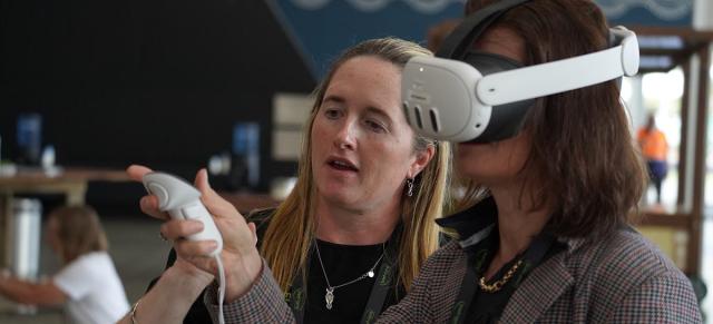 image of two women demonstrating virtual reality