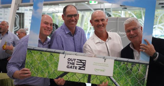 image of B+LNZ staff at Out the Gate conference standing behind sign